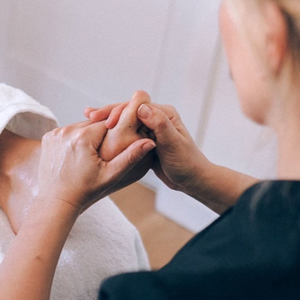 Therapist giving a reflexology massage on feet