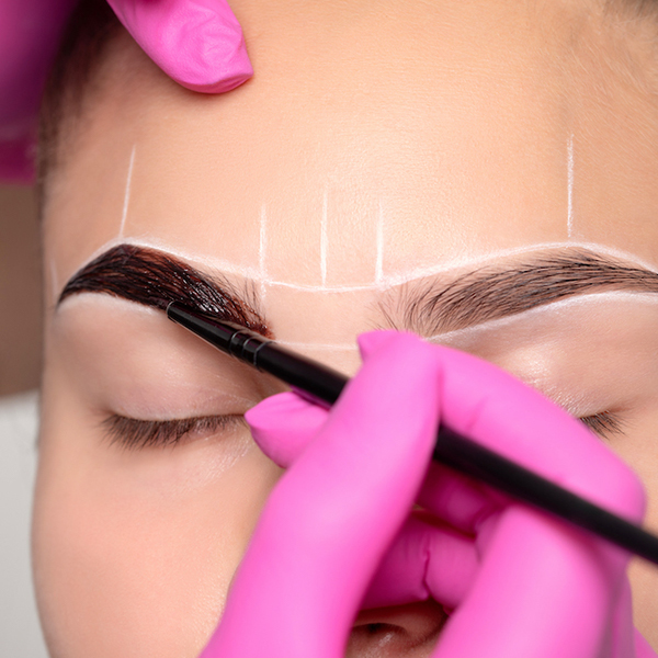 Woman getting her brows defined at home