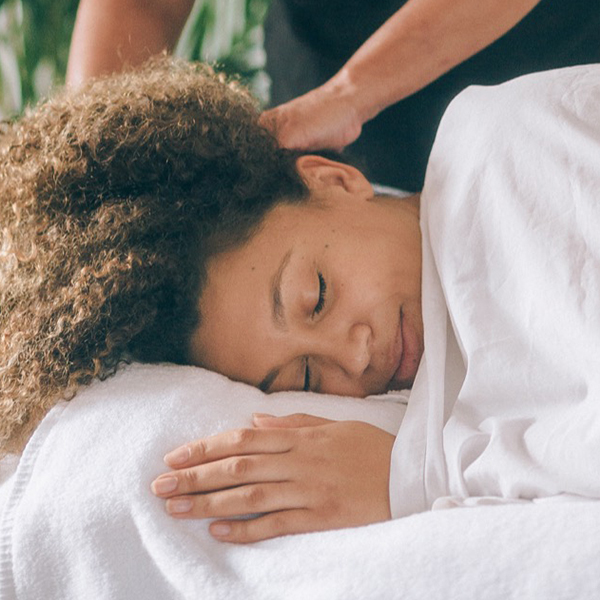 New mum relaxing during a postnatal massage at home