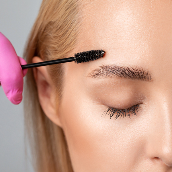 Woman getting her brows laminated at home