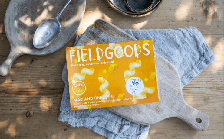 Tabletop laid with a chopping board and fieldgoods mac and cheese ready meal