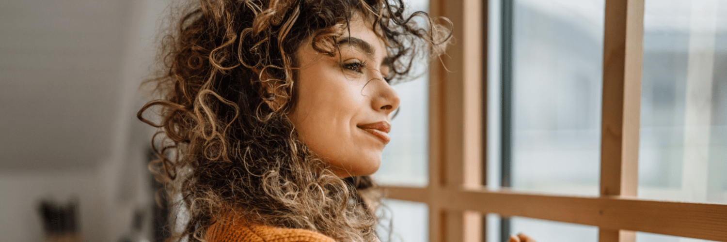 Woman looking happily out of the window