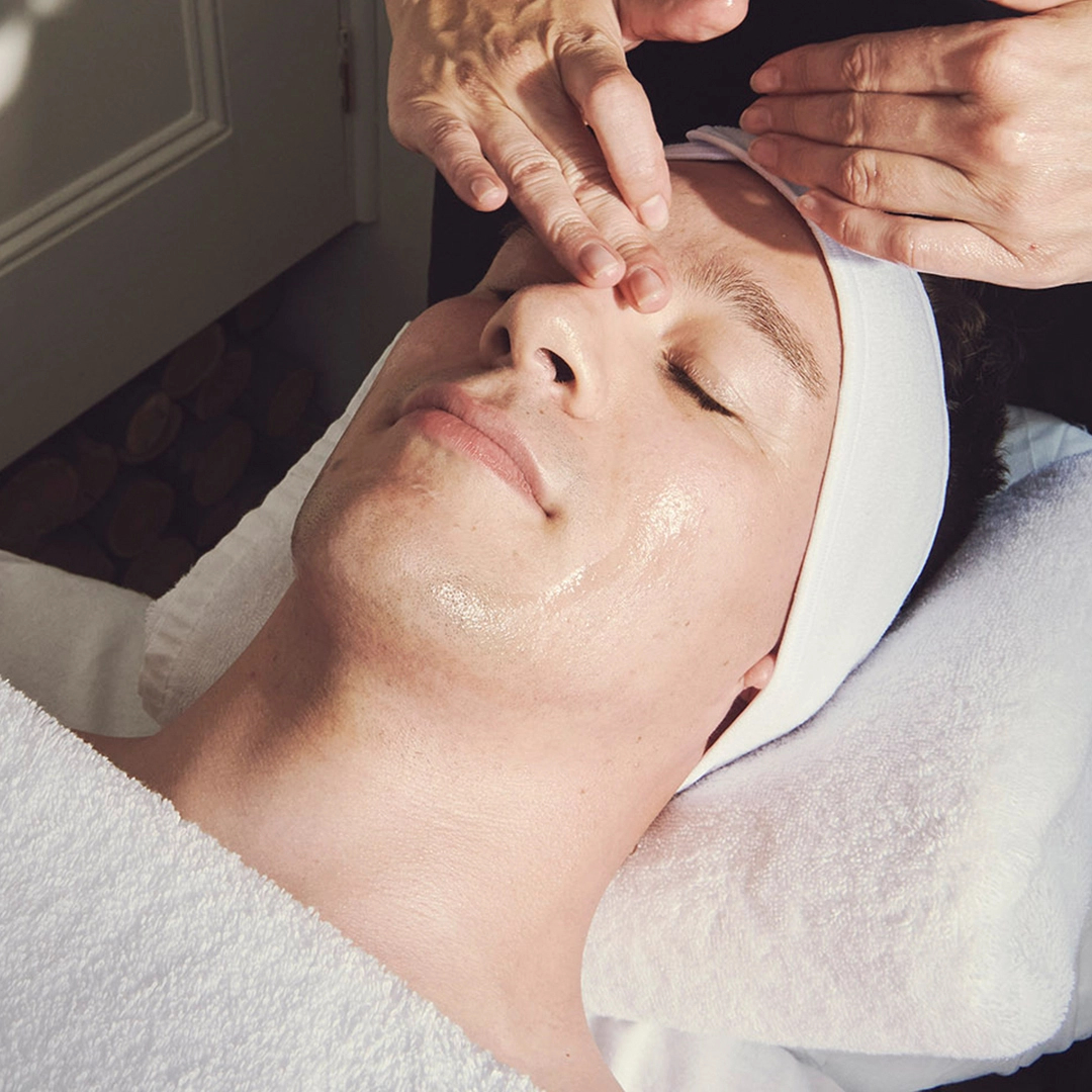 Male client enjoys deep cleansing facial at home
