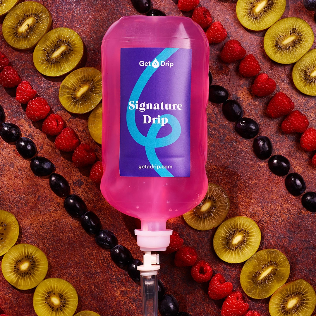 Get a drip's signature drip is artfully photographed on a backdrop of fresh kiwifruit slices, raspberries and olives