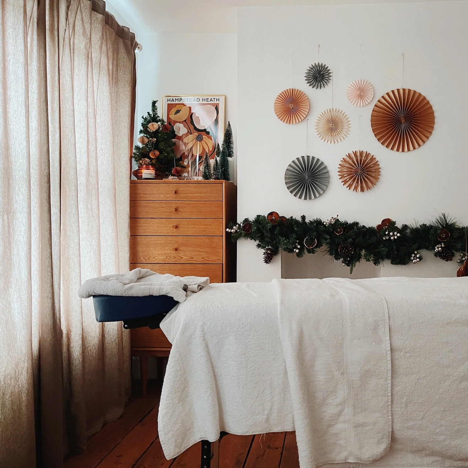 A cosy London apartment at Christmas with a massage table set up with towels
