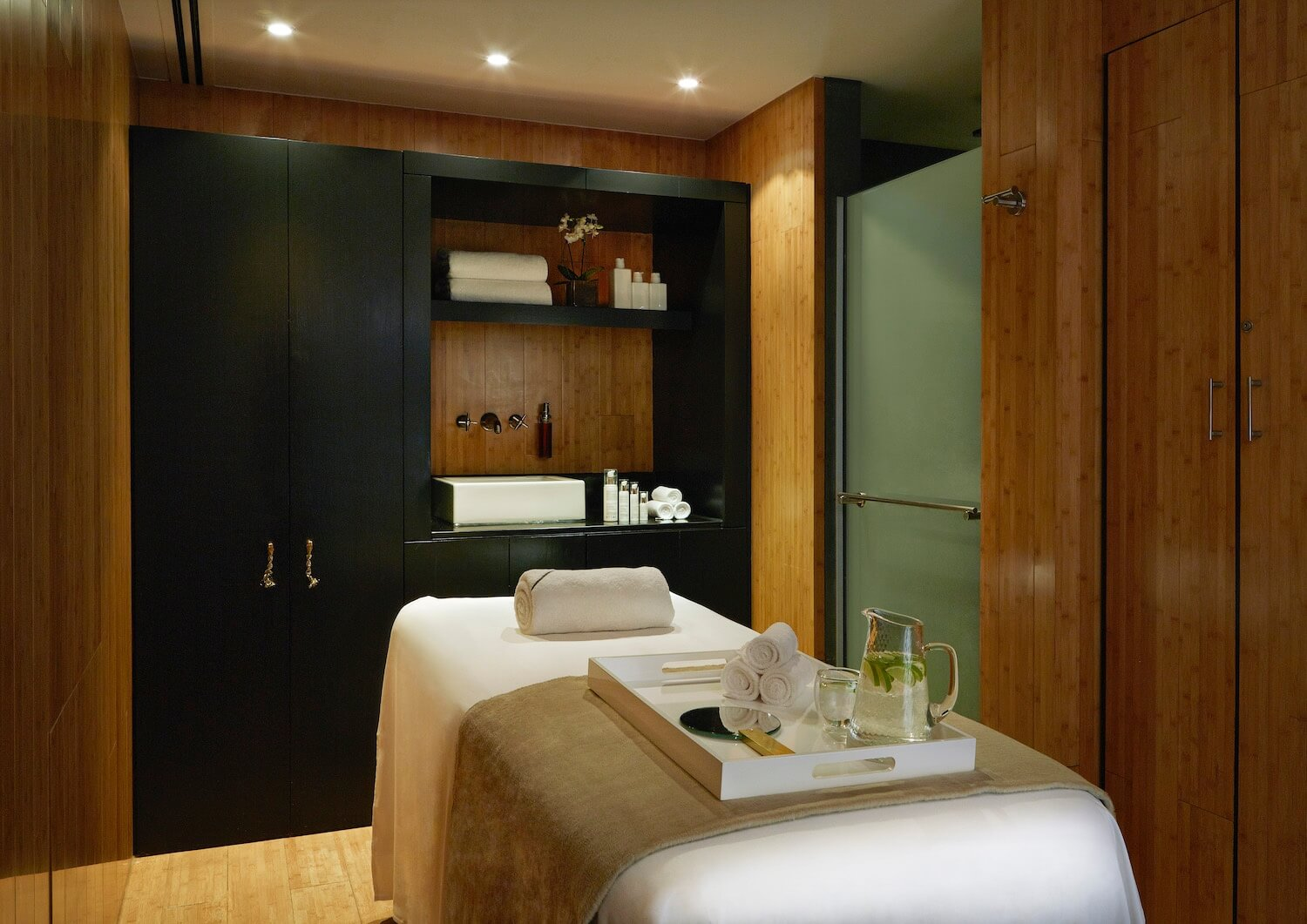 Massage table in a wooden-clad treatment room at the Rosewood hotel spa in London