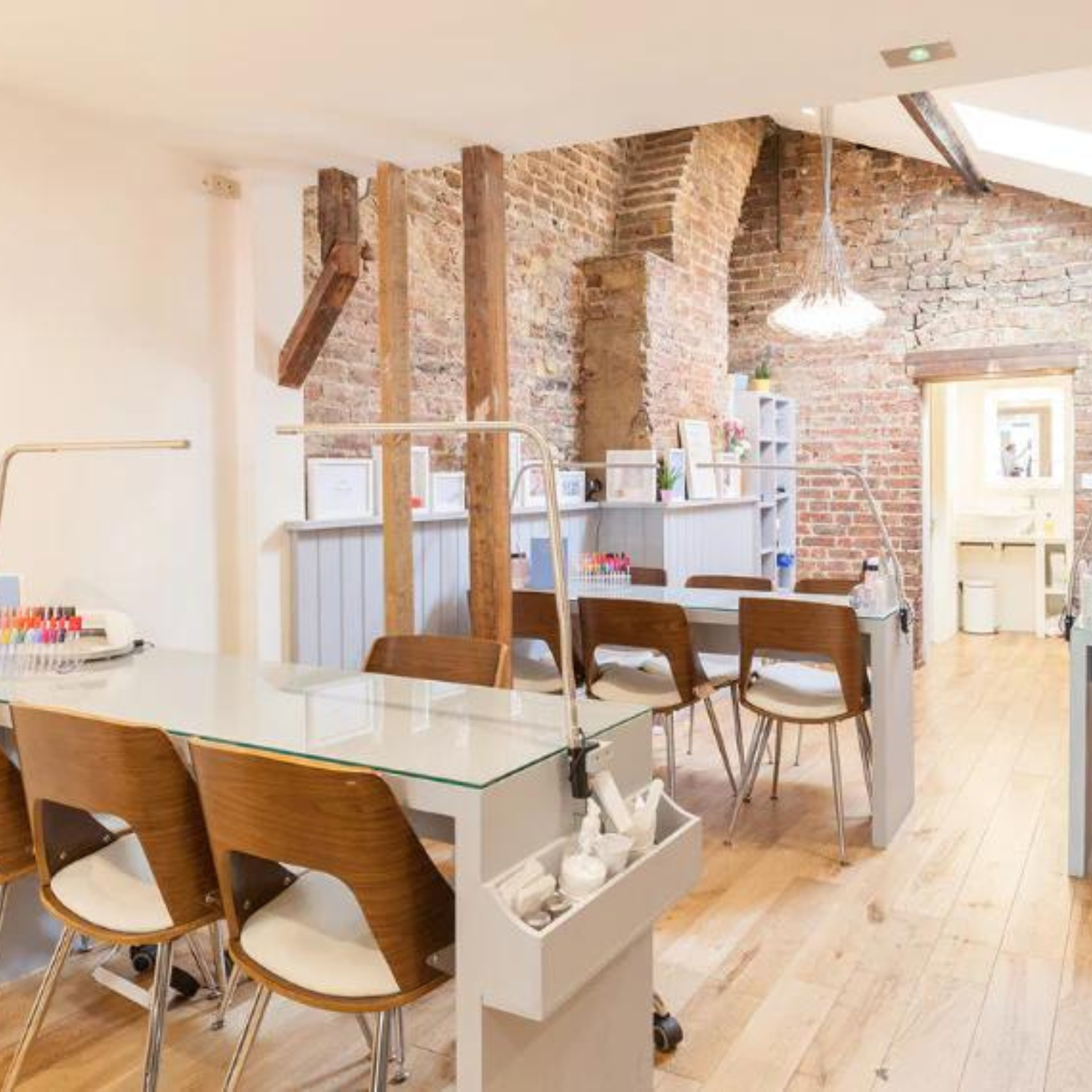Best nail salon in London, image of London Grace in Clapham with desks, chairs and brick walled building