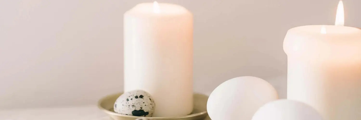 Relaxing image of lit candles and marble ornaments on a table