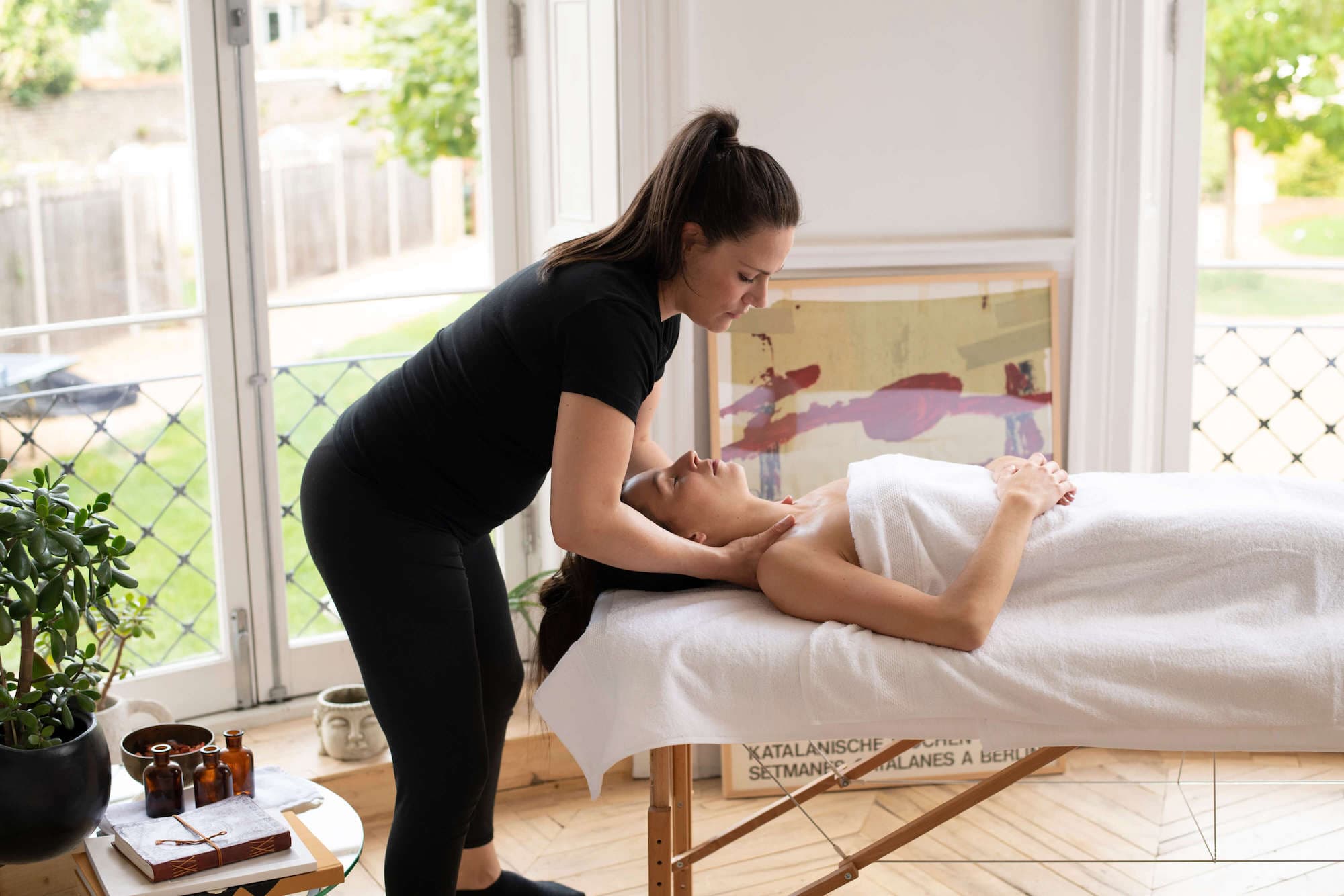 Client enjoys full body massage as therapist massages shoulders