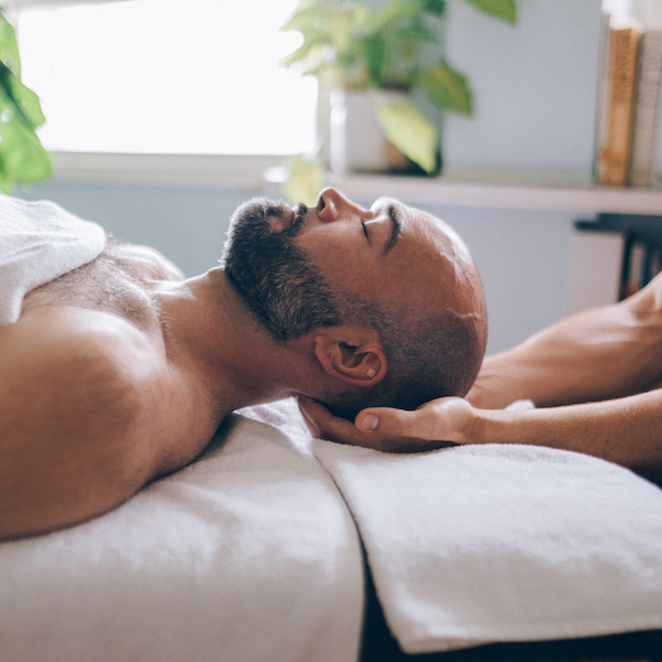 Man lying down at home for an osteopathy consultation