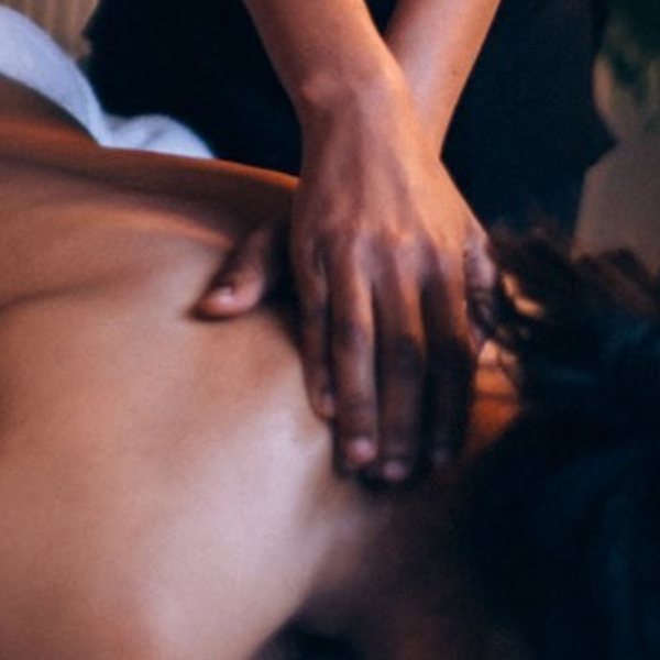 Hands massaging patient's lower neck