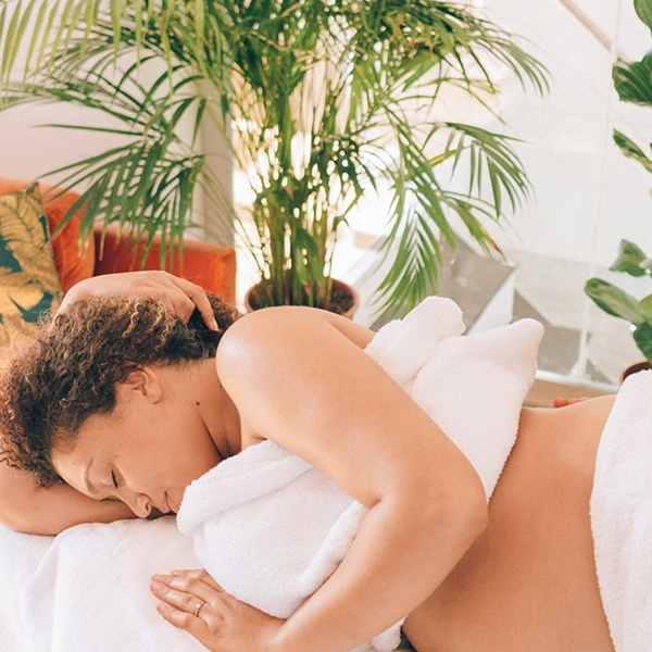 Pregnant woman lying down during a pregnancy massage 