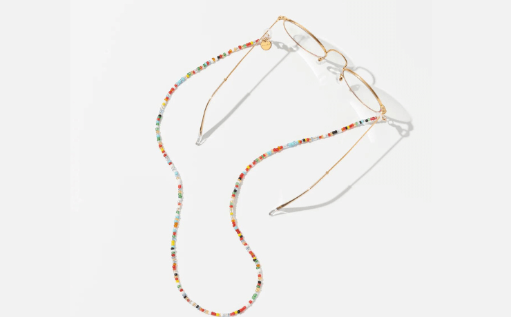 Colourful glasses chain made of small beads attached to brass rimmed glasses